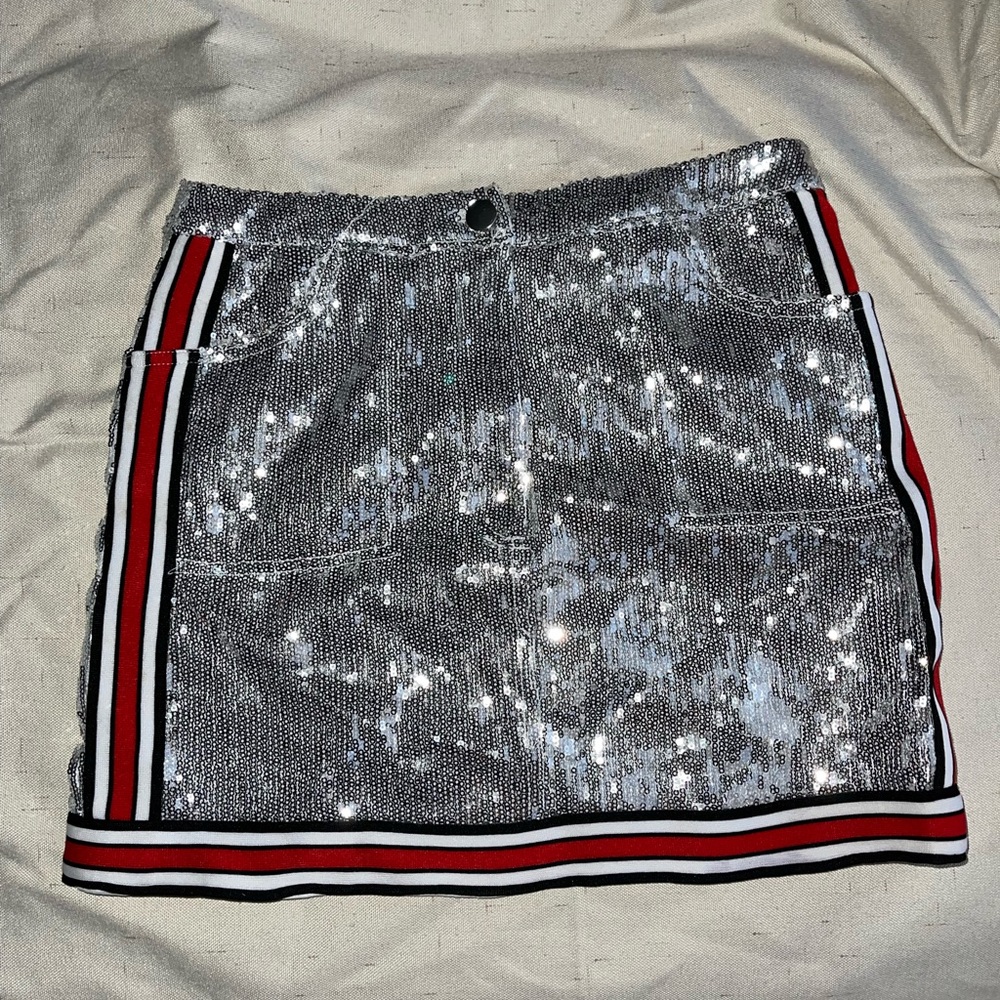 Silver sequin skirt with red white and blue stripes on side and bottom of skirt